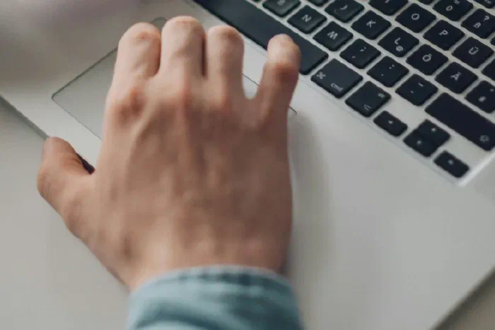 Hands working at a laptop keyboard, managing ongoing company administration