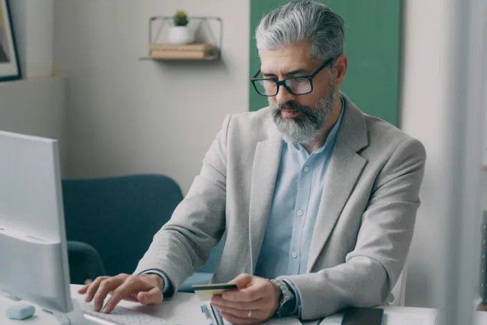 A company director reviewing payroll and benefits paperwork