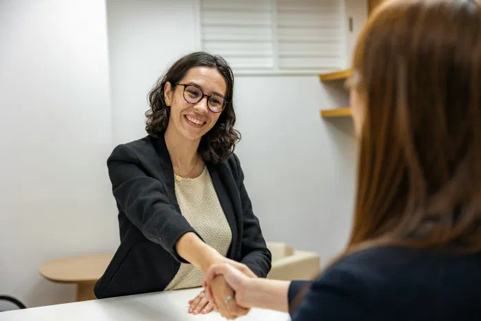 A business owner shaking hands with a new hire