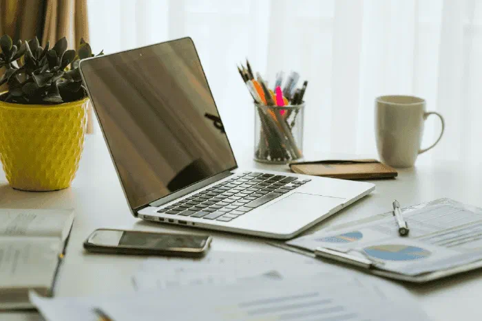 An organised home office desk set up for monthly bookkeeping and financial planning