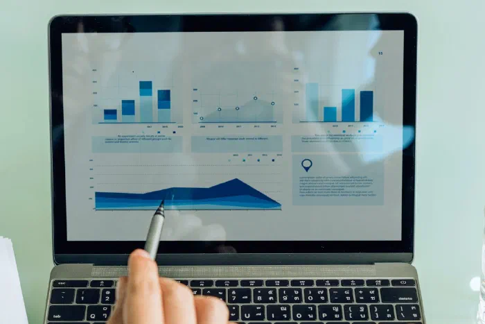 A business owner reviewing financial data and charts on a laptop