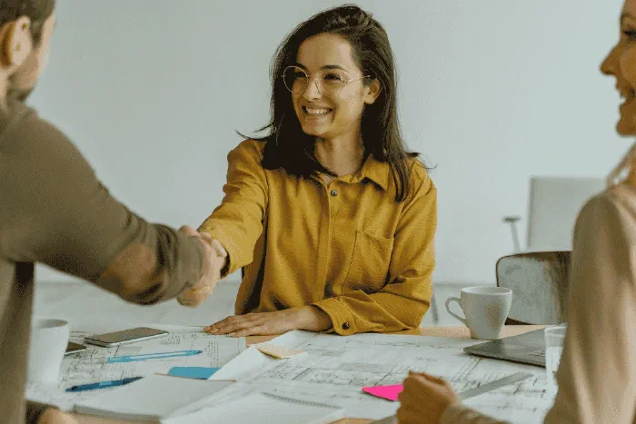 Two business professionals shaking hands during a collaborative meeting Two business professionals shaking hands during a collaborative meeting