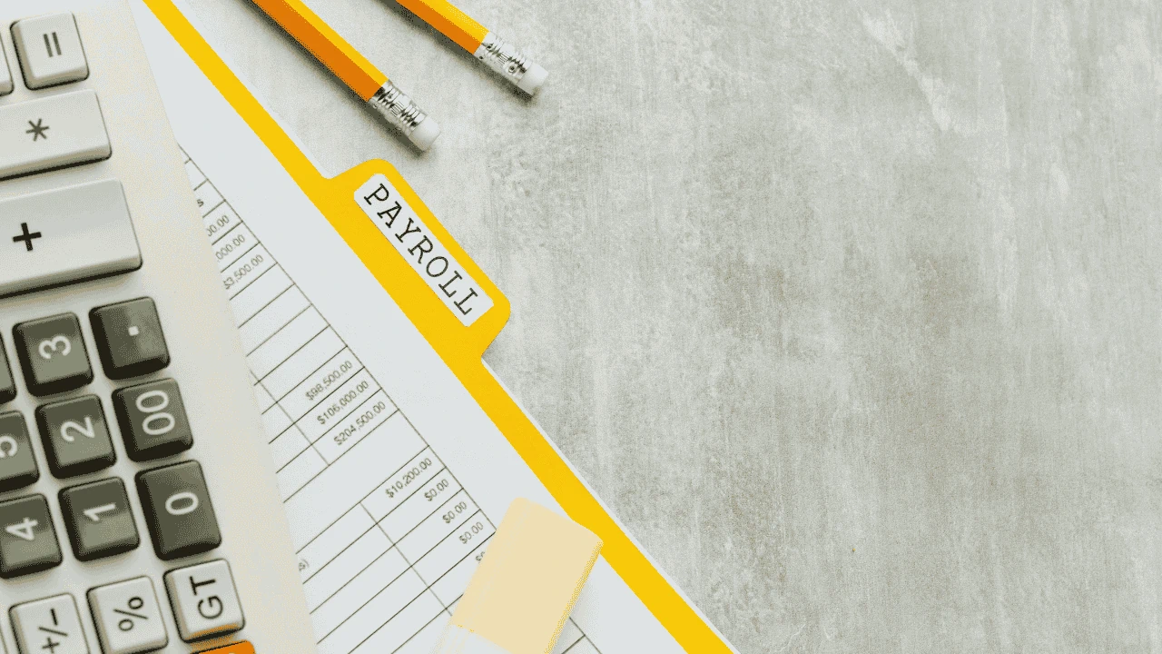 Payroll documents and pencils on a desk representing Employment Detail Summary Ireland.