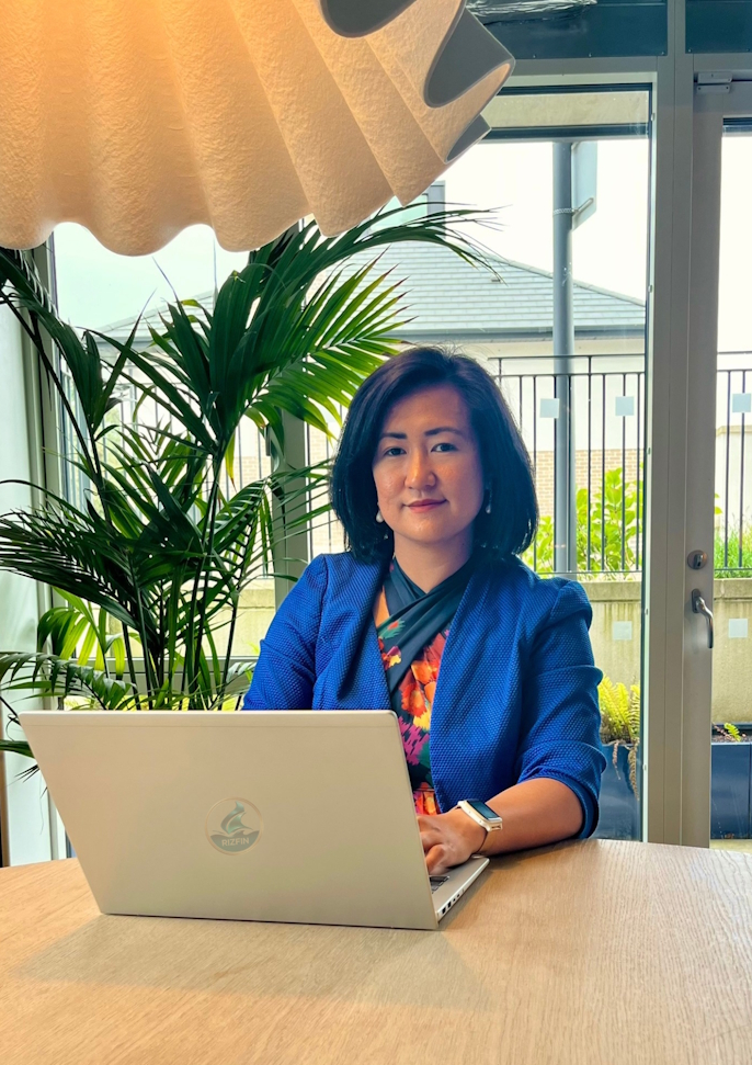 Danica Rizza Gutierrez is the founder of RizFin - working on a laptop, helping small businesses grow through clear financial systems and accounting services in Ireland.