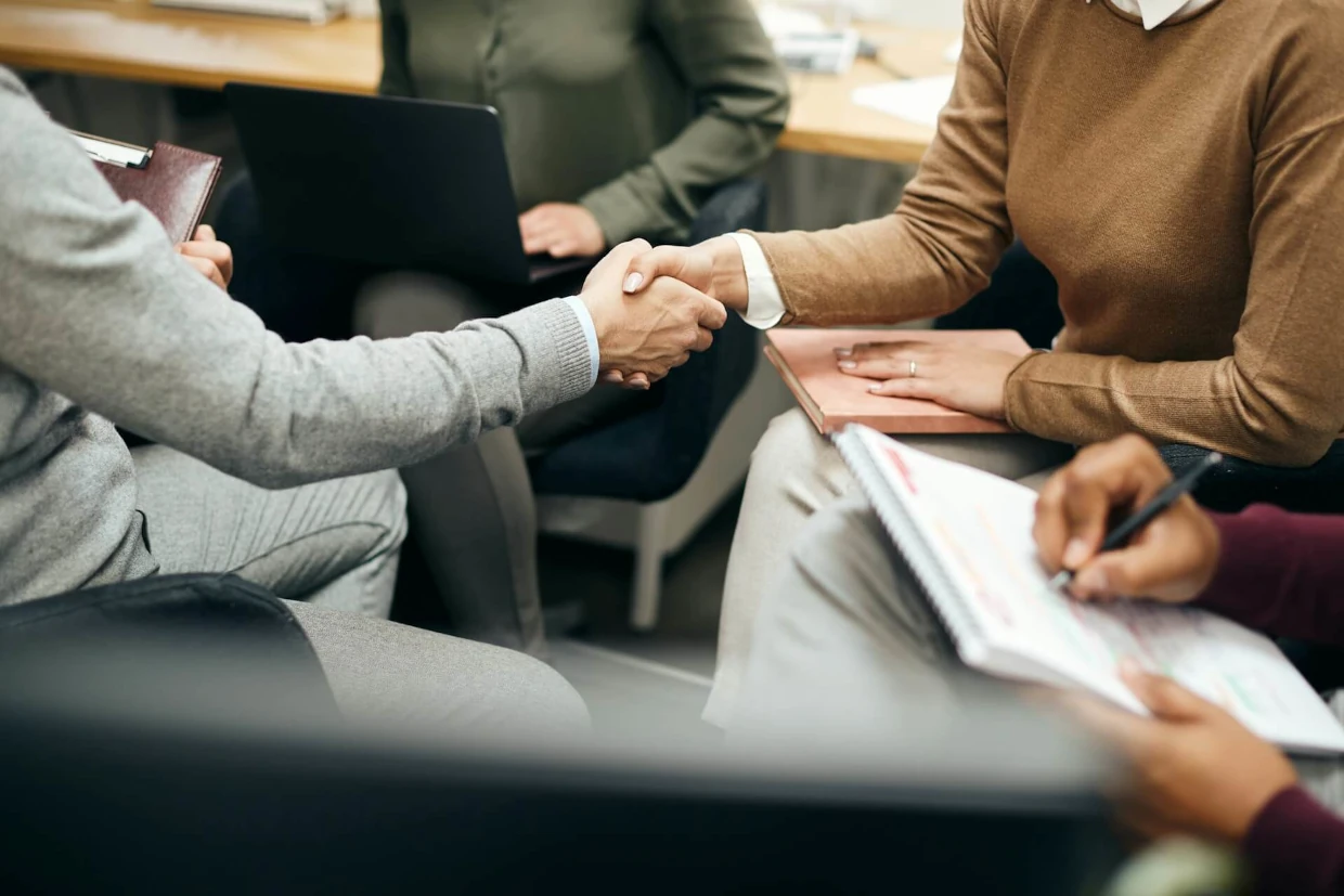 Business professionals shaking hands, representing bookkeeping and accounting services for small businesses in Ireland, supporting confident business growth.
