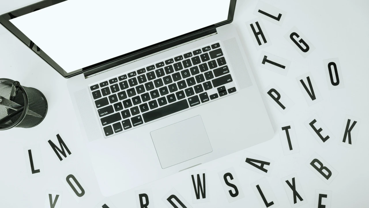Workspace with laptop and scattered letters representing a finance and tax terms glossary Ireland