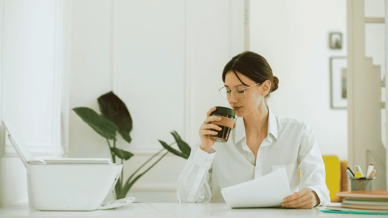 Small Business Accountant in Ireland working calmly at her desk with coffee and documents