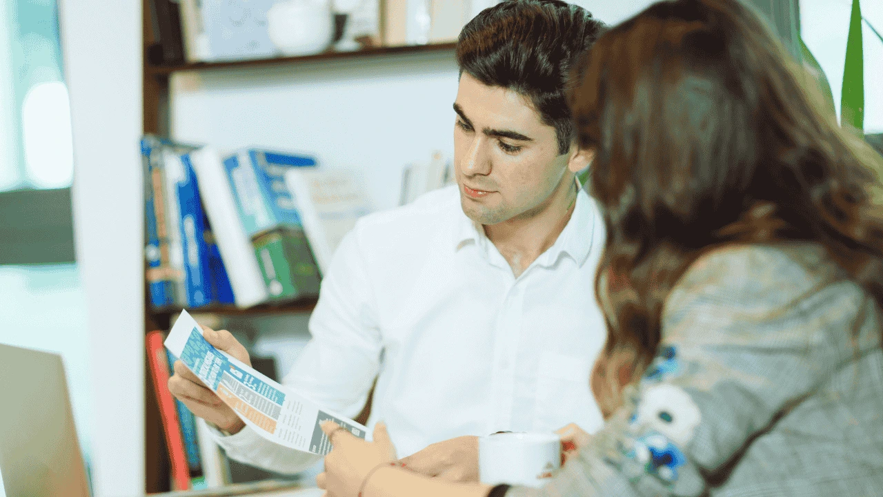 Financial advisor discussing business setup steps from the Self-Employment Guide in Ireland 2025 with a client.