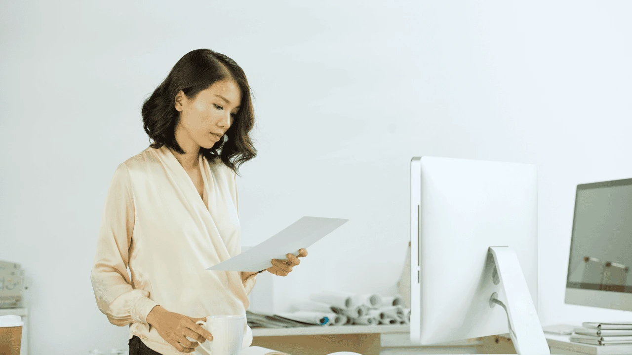 Director Payroll in Ireland 2025 – business owner reviewing payroll documents in office