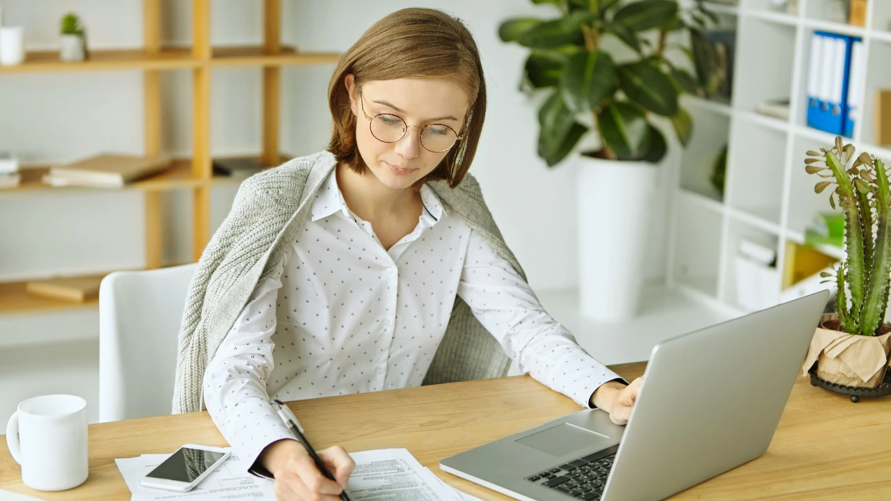 SME owner reviewing financial reports with outsourced bookkeeping services in Ireland on laptop