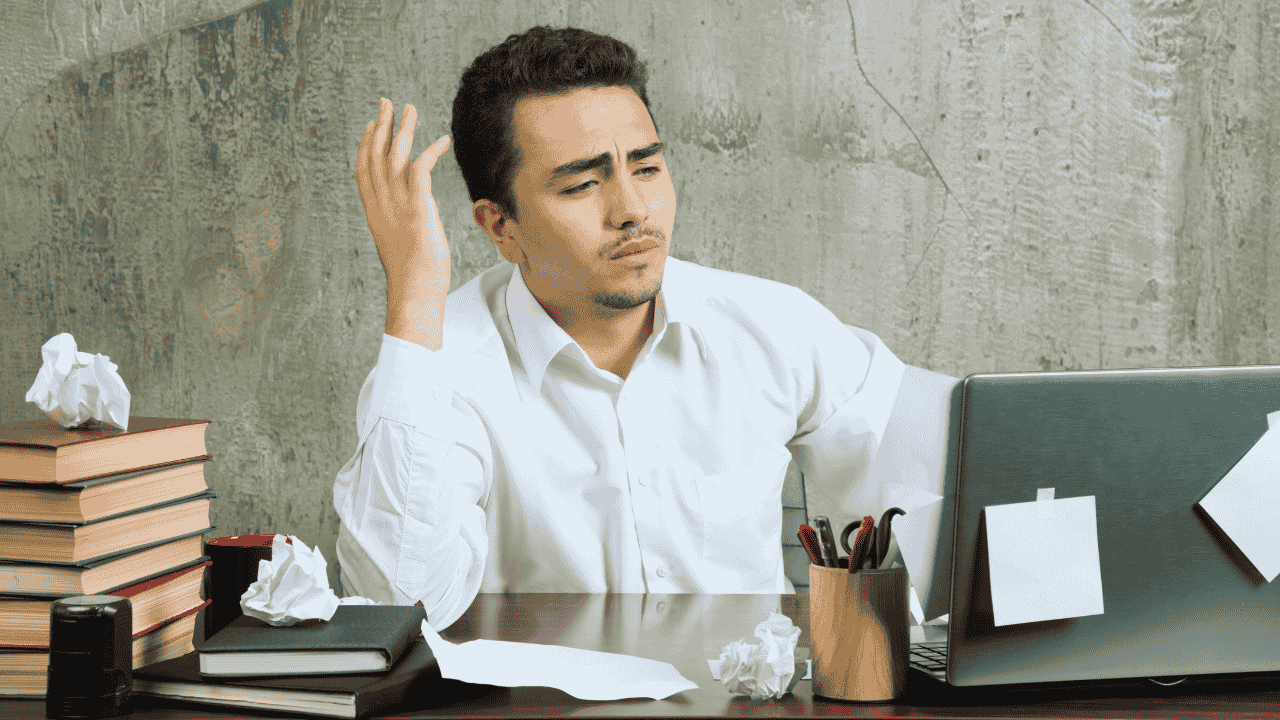 Frustrated accountant surrounded by paperwork, highlighting the need for accounting systems for small businesses in Ireland.